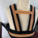 Close-up display of the adjustable shoulder straps and reflective pattern on a mannequin.