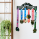 Black metal "Just Keep Running" medal display mounted on a white wall filled with colorful marathon finisher medals hanging from its bars.