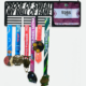 Black metal medal and race bib display hanger mounted on wall holding running medals and bib number