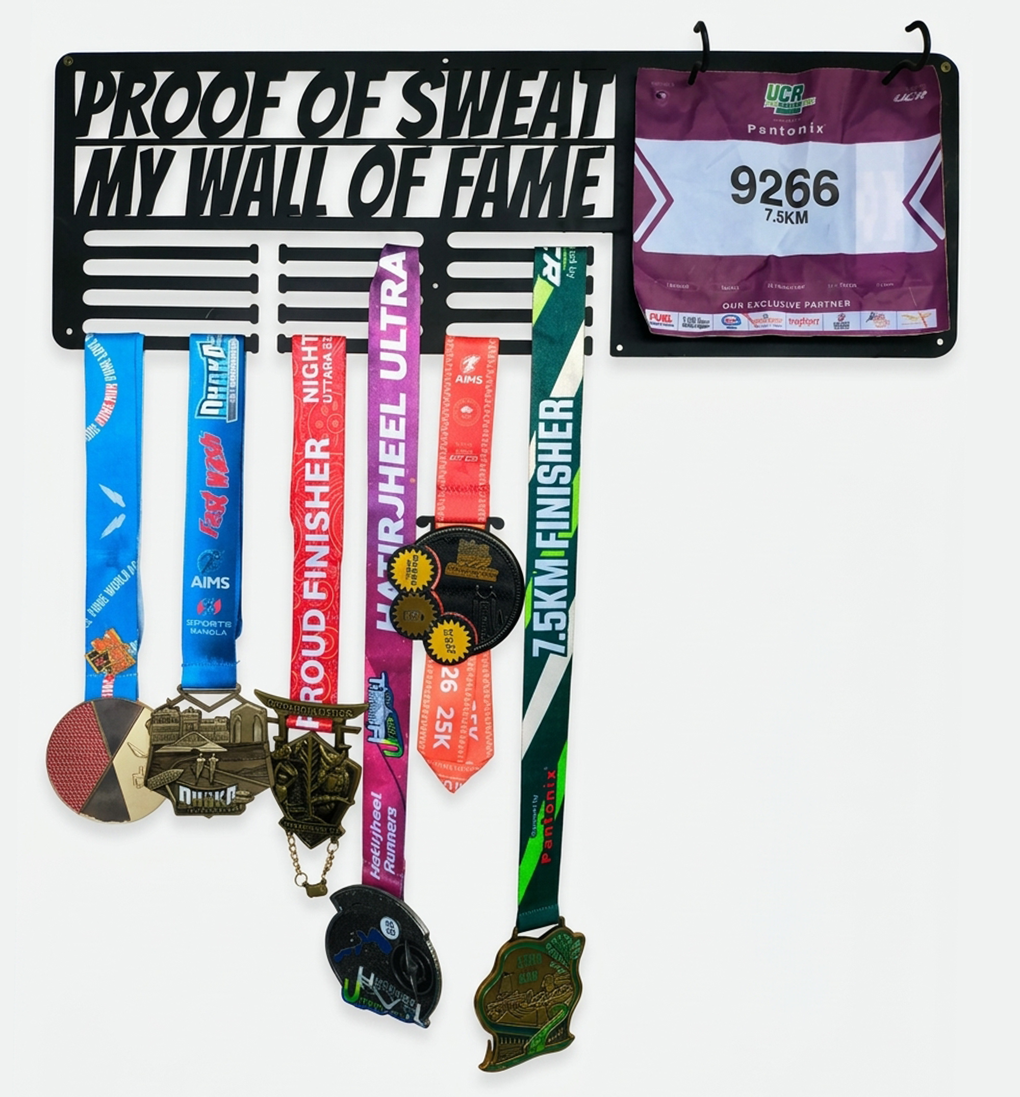 Black metal medal and race bib display hanger mounted on wall holding running medals and bib number